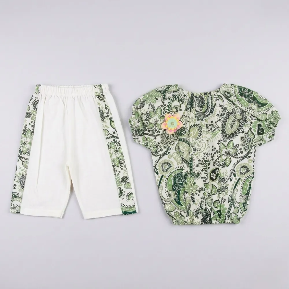 Green and white paisley print shirt with ruffled sleeves and white pants with green paisley print down the sides.