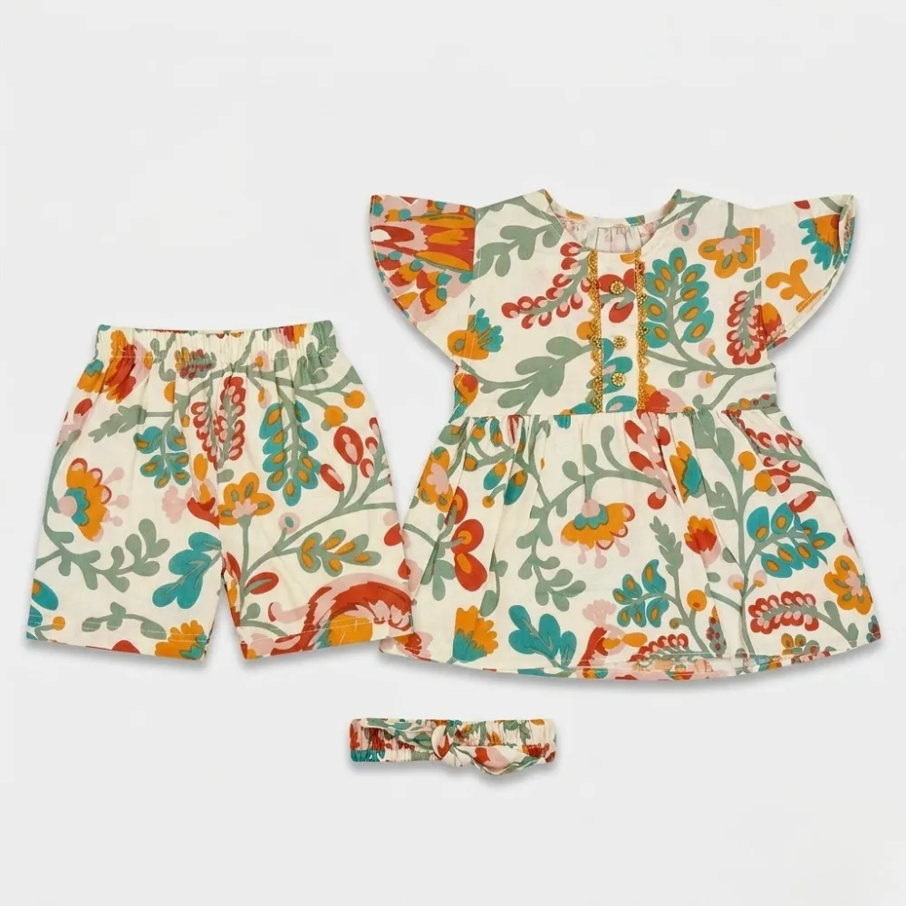 Floral outfit for kids, consisting of a short-sleeved top, shorts, and headband. The clothing set features a white base with colorful floral patterns in shades of orange, blue, red, and green.