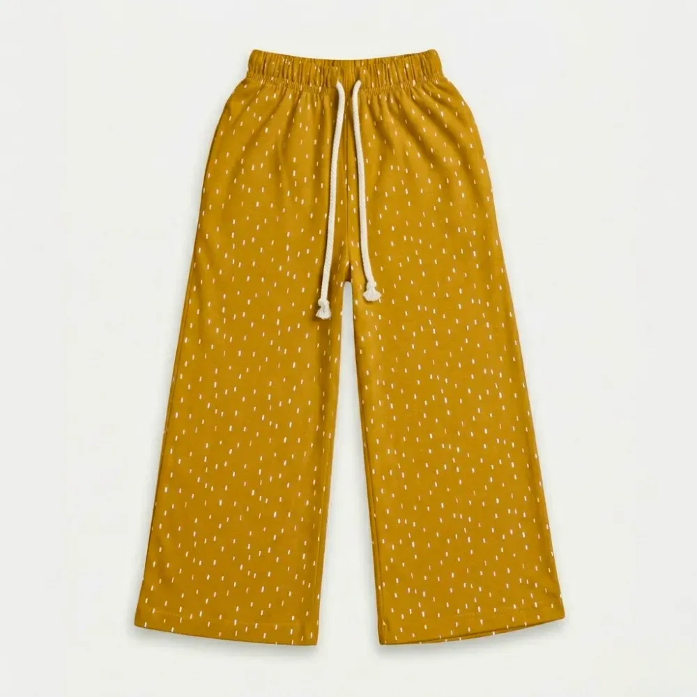 Yellow wide-leg pants with white polka dots and drawstring waistband
