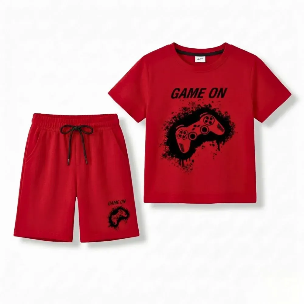 red gaming outfit for kids, including a short-sleeve t-shirt and shorts with black graphic design, game on text, and video game controller print on red background.