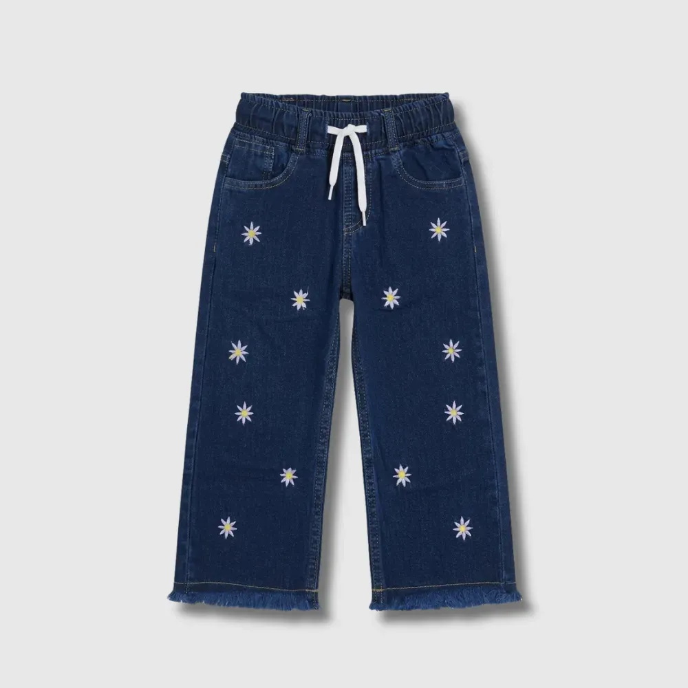 Dark blue denim pants with white drawstring and small white daisies embroidered all over.