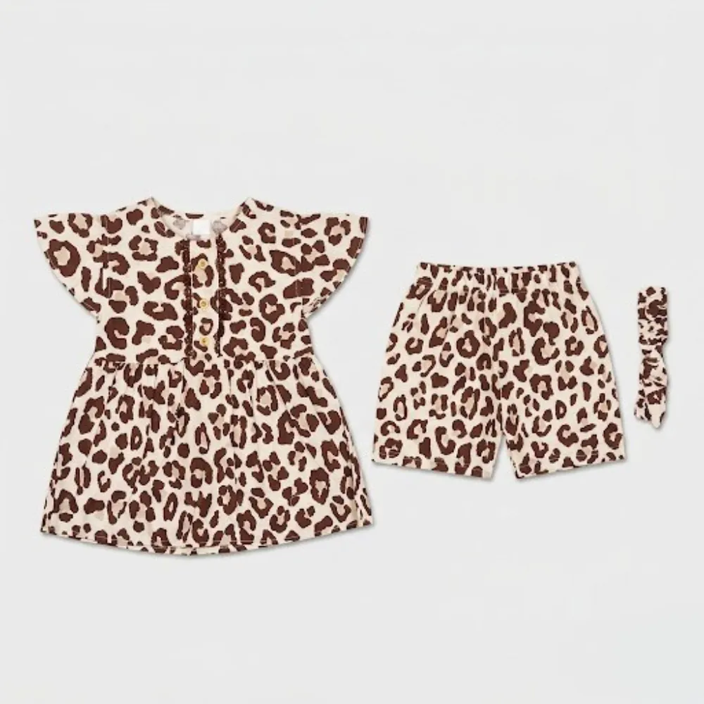A beige and brown leopard print three-piece outfit consisting of a short-sleeved top with buttons, shorts, and a hairband.