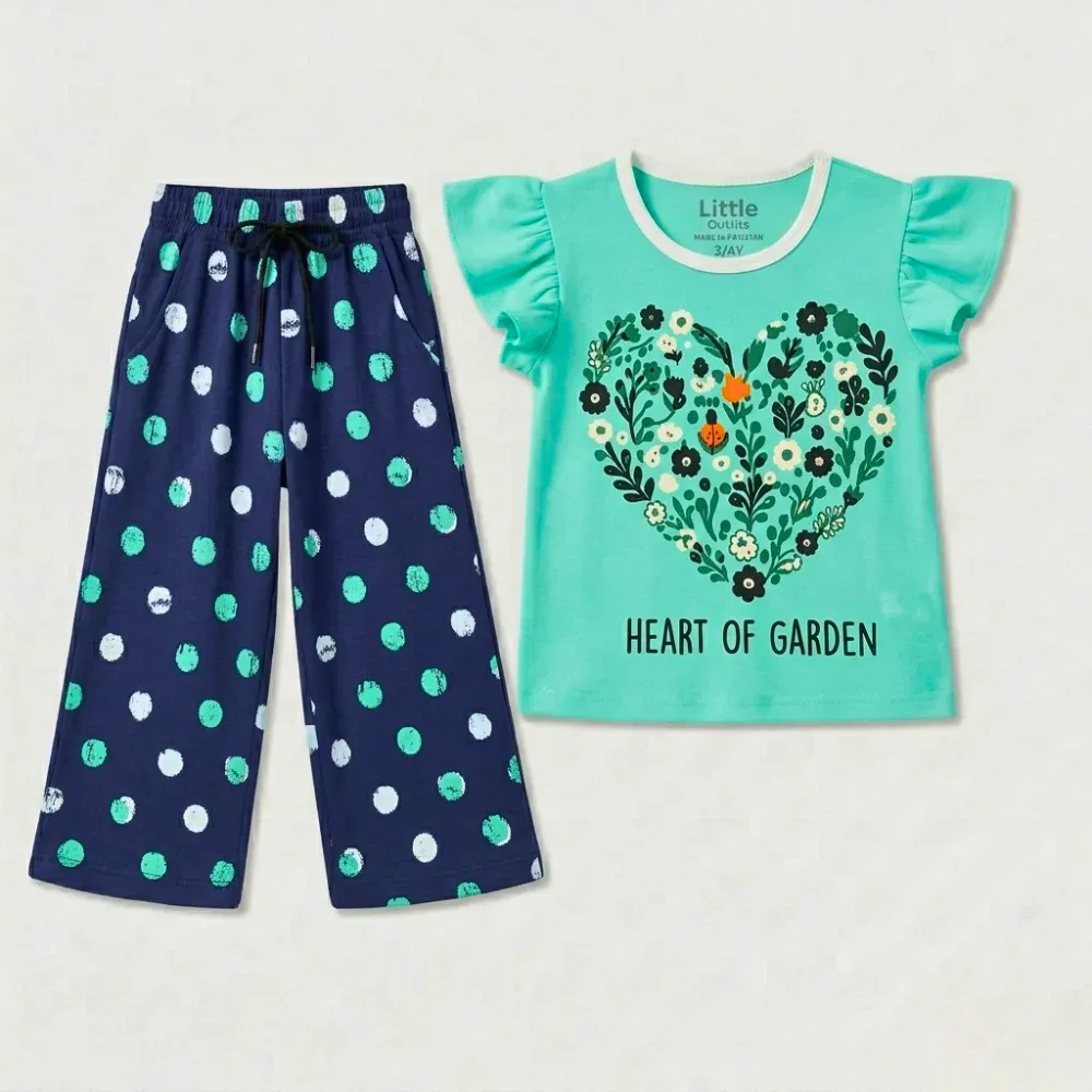 Toddler outfit with navy blue polka dot pants and a mint green graphic t-shirt featuring a heart-shaped floral design and 'HEART OF GARDEN' text.